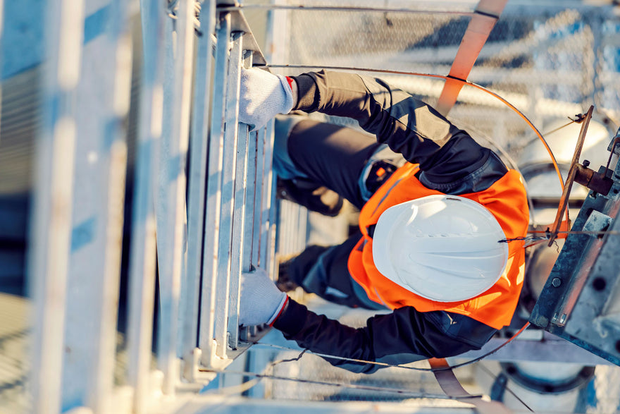 Worker Attached To A Wire Lifeline Climbing A Ladder