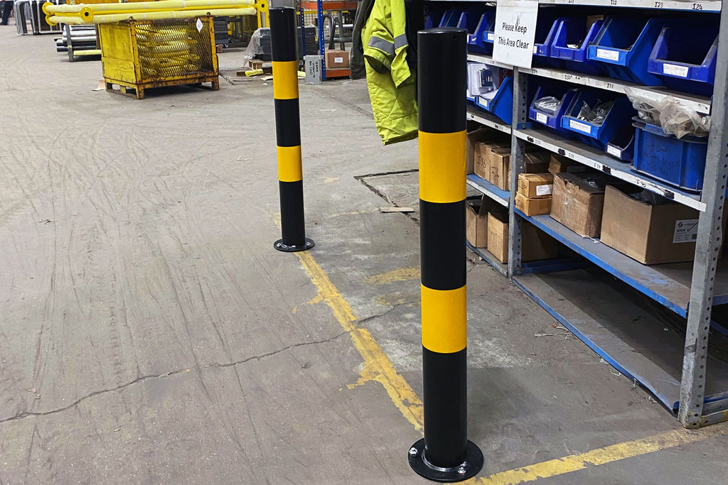 Bolt down yellow and black bollard installed on factory floor