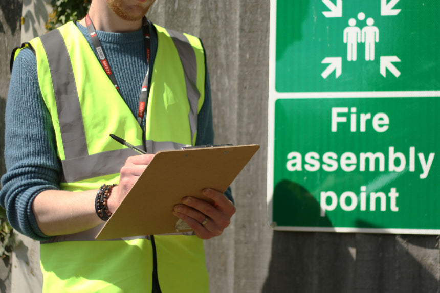 Office Fire Marshall Cheking The Fire Registry At The Fire Assembly Point