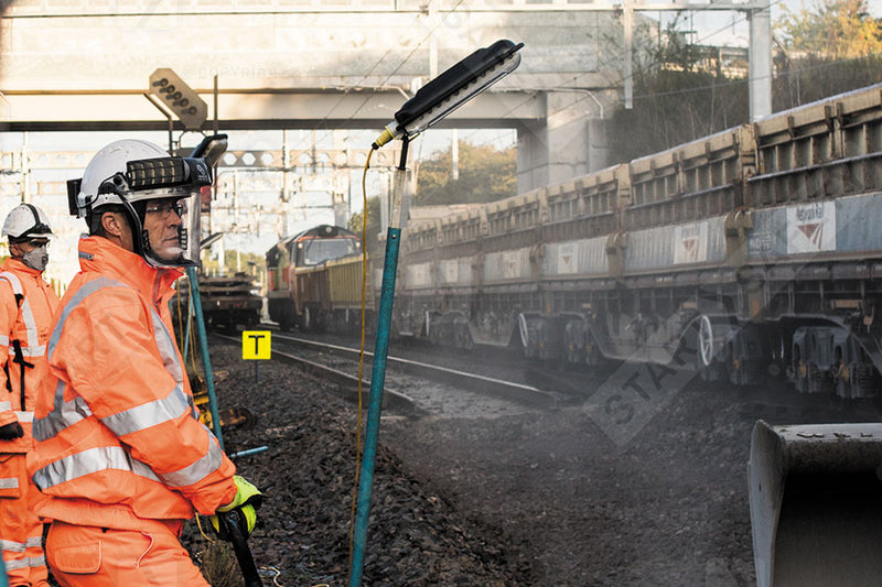 Railway Engineer Wearing Orange Hi-vis Jacket And Trousers