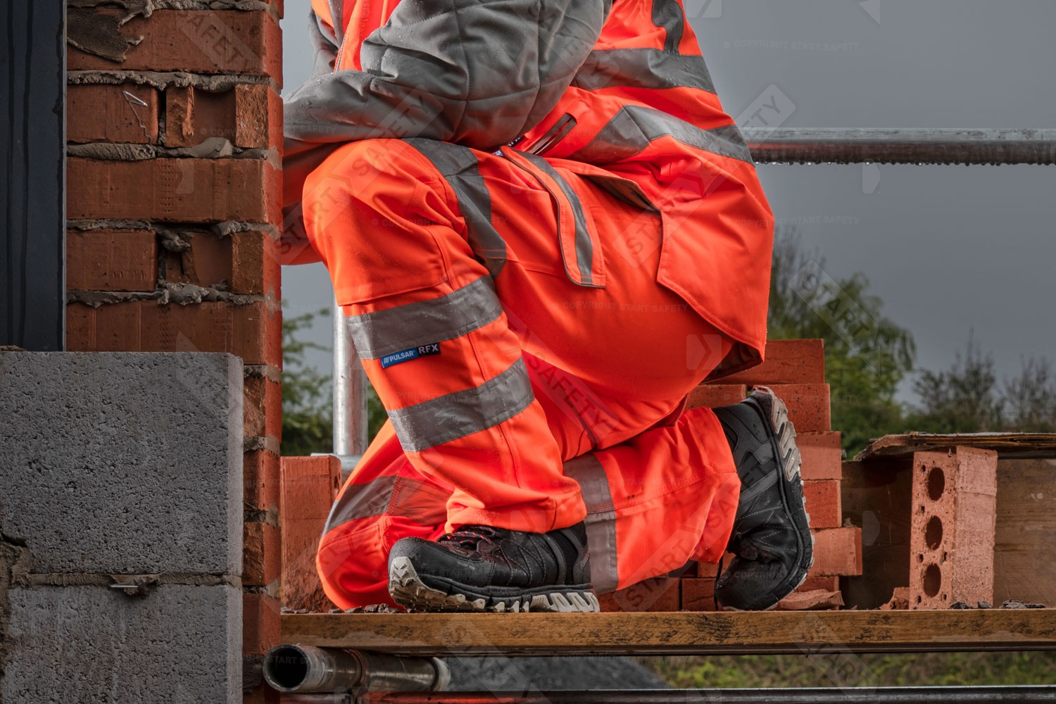 Construction Worker Wearing Pulsar PR336 Orange Hi Vis Combat Trousers