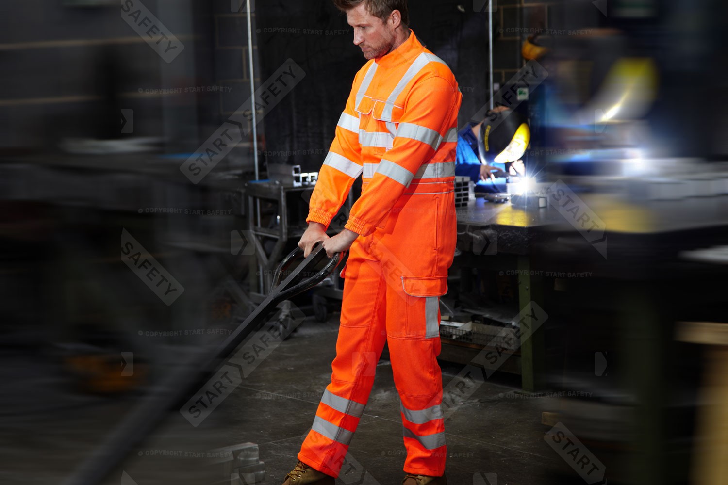 Worker At A Workshop Wearing Pulsar PR339 Orange Hi Vis Comabt Overalls