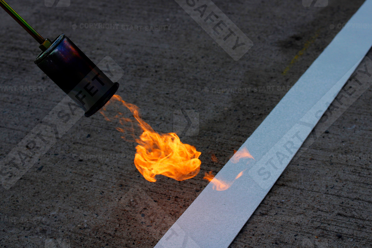 Close up of thermoplastic marking being applied with gas burner