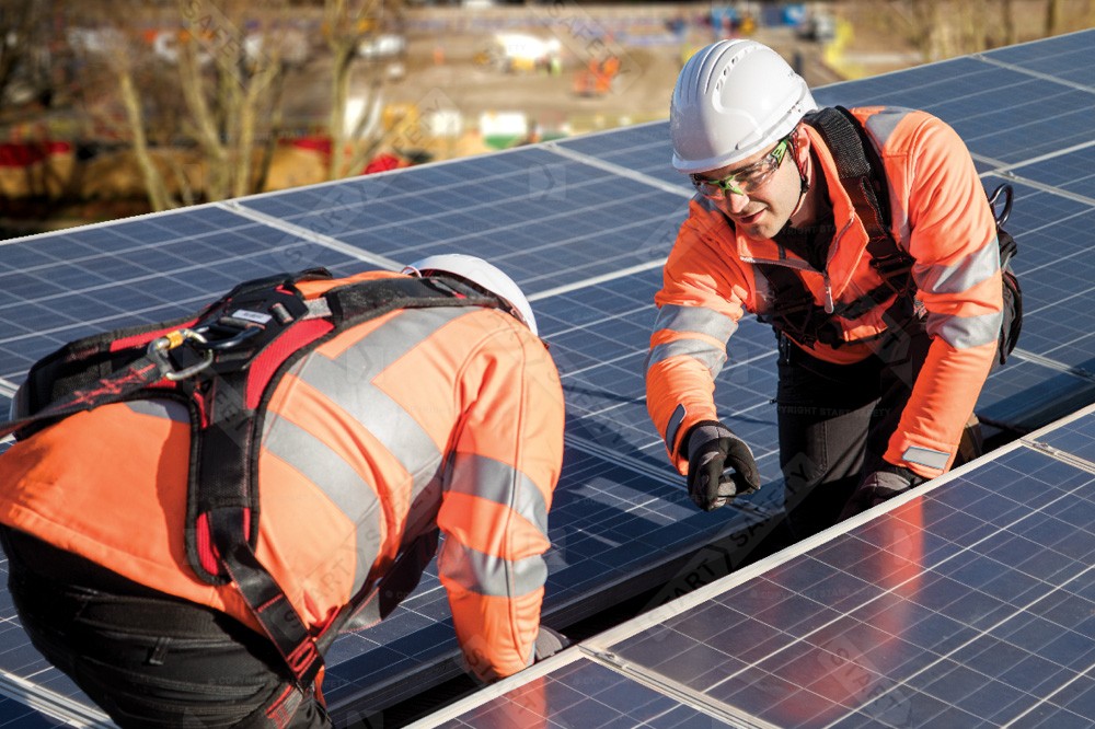 Workers With Fall Restraint Equipment Installing Solar Panels