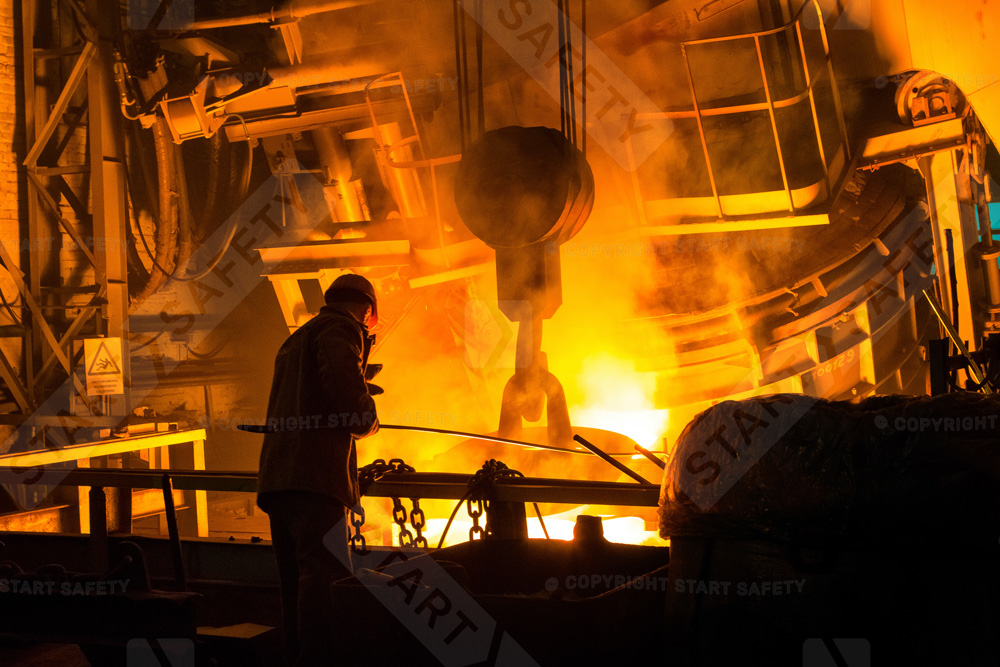 Man Wearing PPE Working In A Loud Metal Foundry
