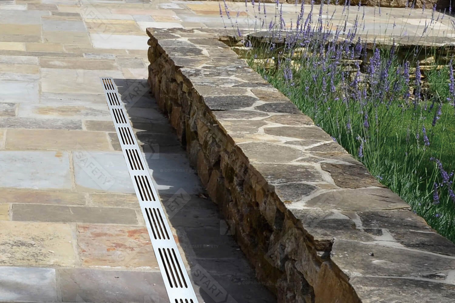 Alusthetic Drainage Channel Installed Aesthetically Against Patio Wall