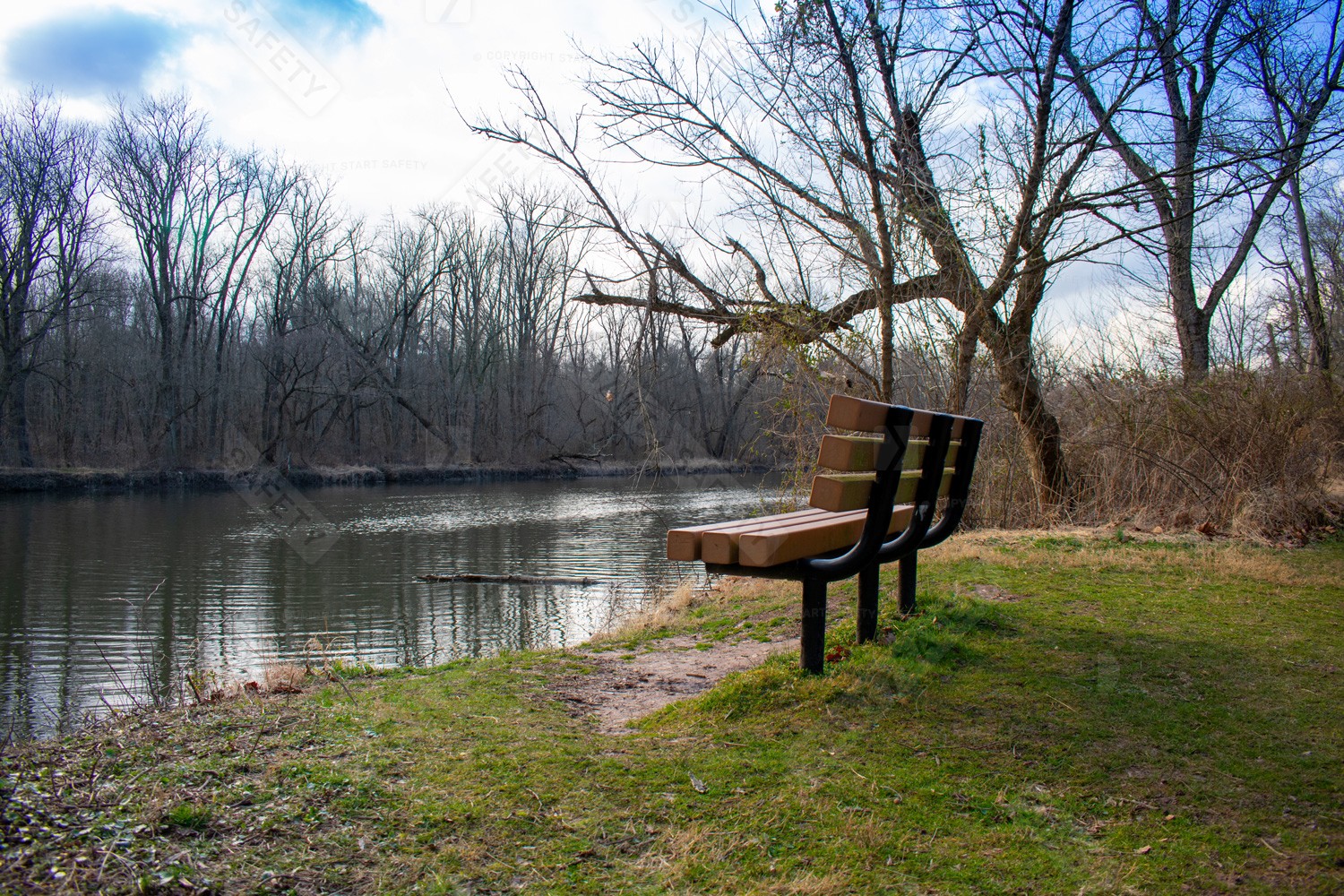 STeel and Wooden Bench With Angled Backrest Overlooking River
