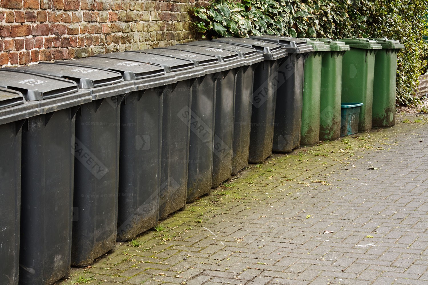 A Large Amount Of Wheelie Bins That Could Be More Discretely Put Away Within A Shelter