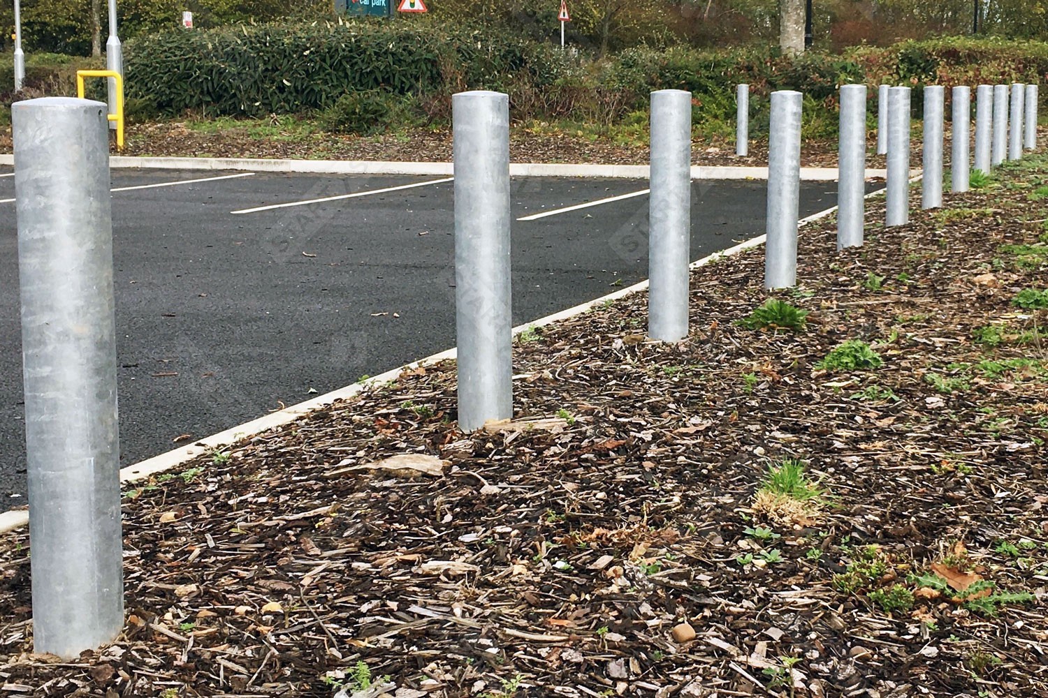 Standard cast in galvanised bollard installed in car park boundary