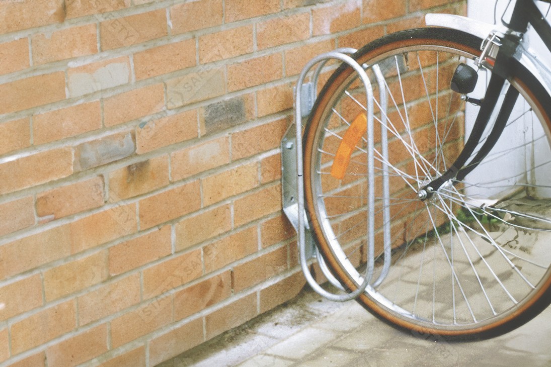 Procity Fixed Wall Mounted Bike Rack Installed Against Wall in Use By Single Cycle