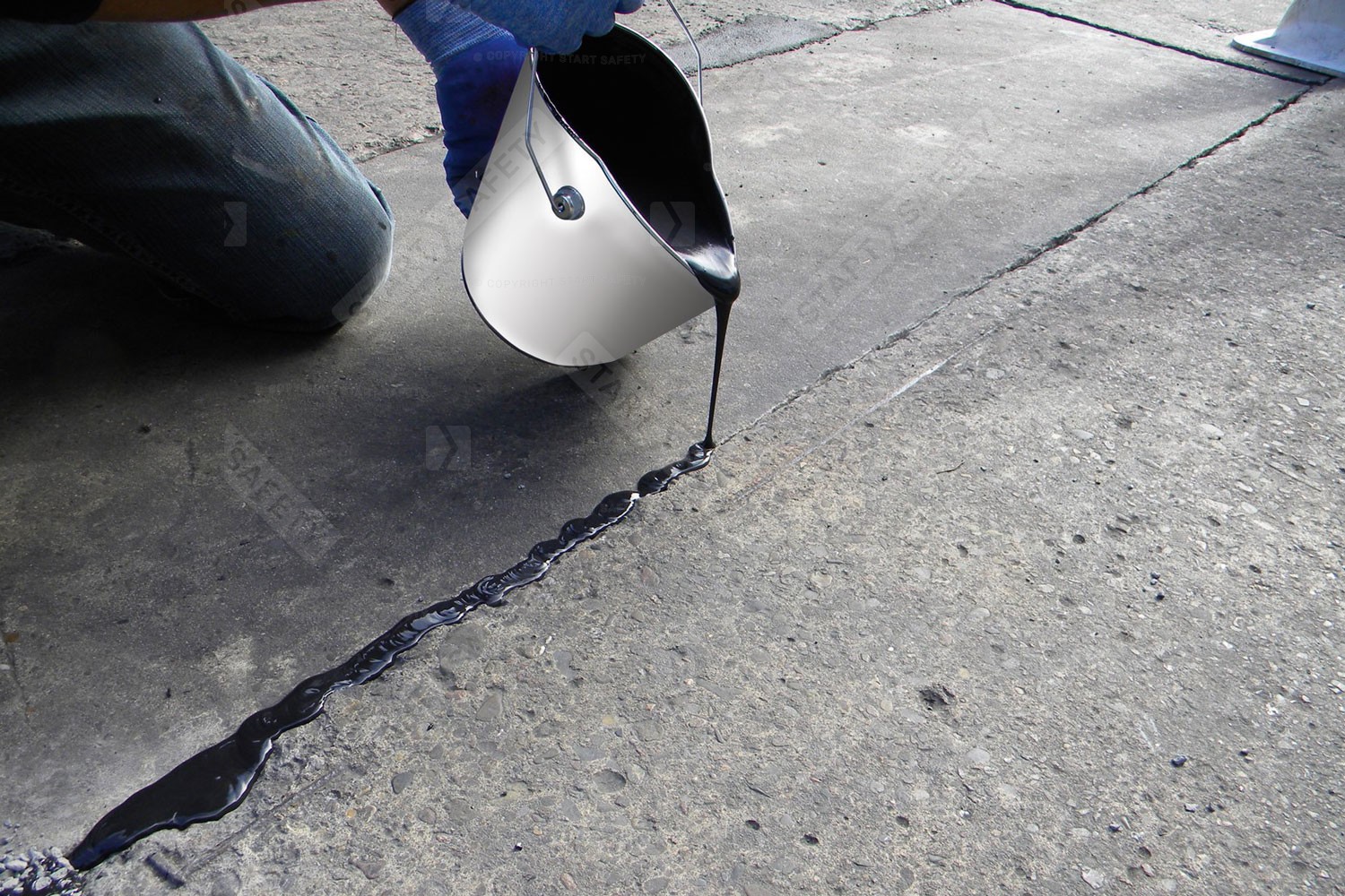 Restore Crack Repair Being Poured Into Small Crack On Concrete