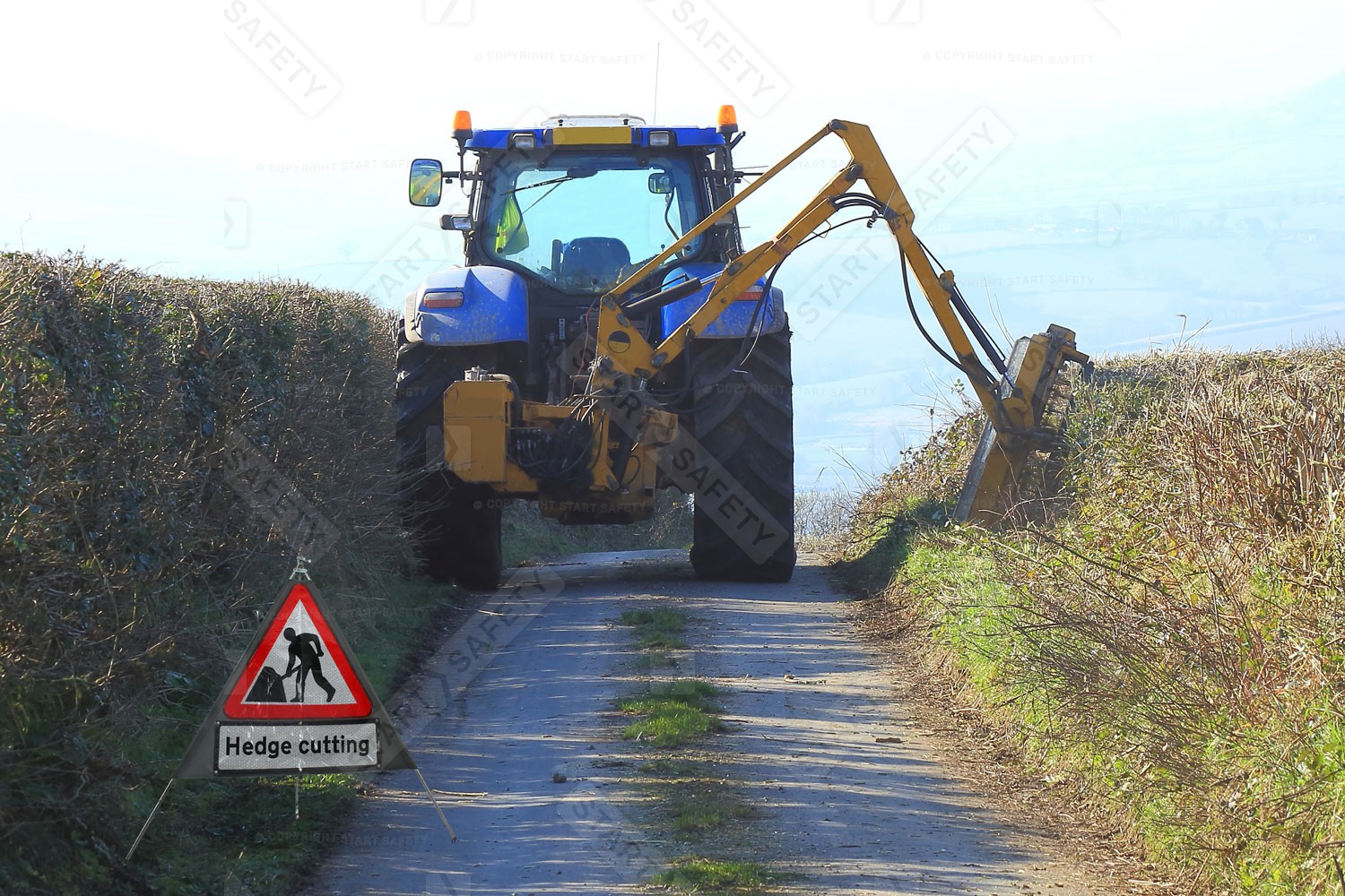 Men At Work Hedge Cutting Road Sign In Use