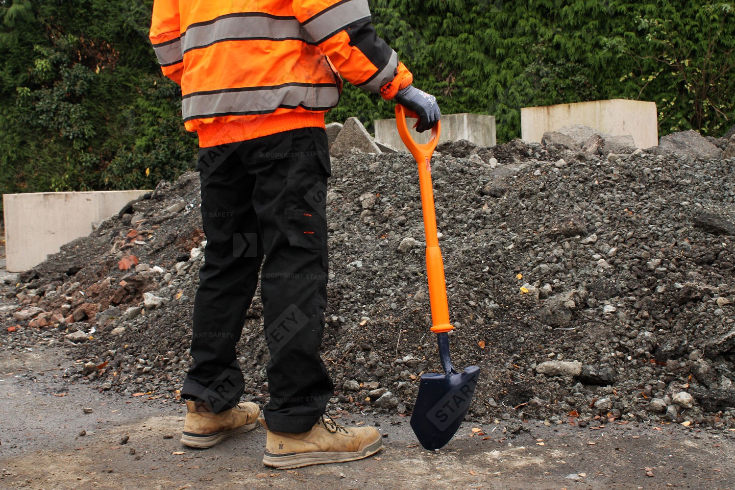 Man contemplating work ahead whilst holding shovel