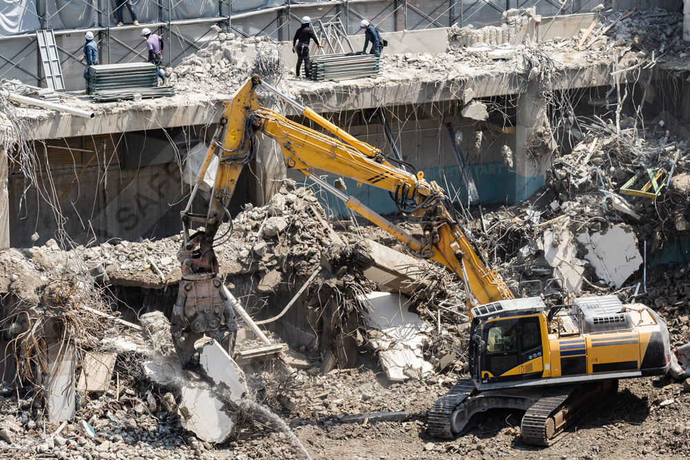 Workers With Hard Hats In A Demolition Site