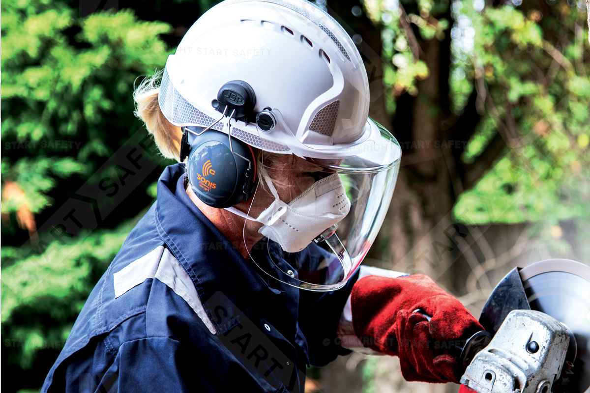 Worker Using A Saw While Wearing A Hard Hat With Visor